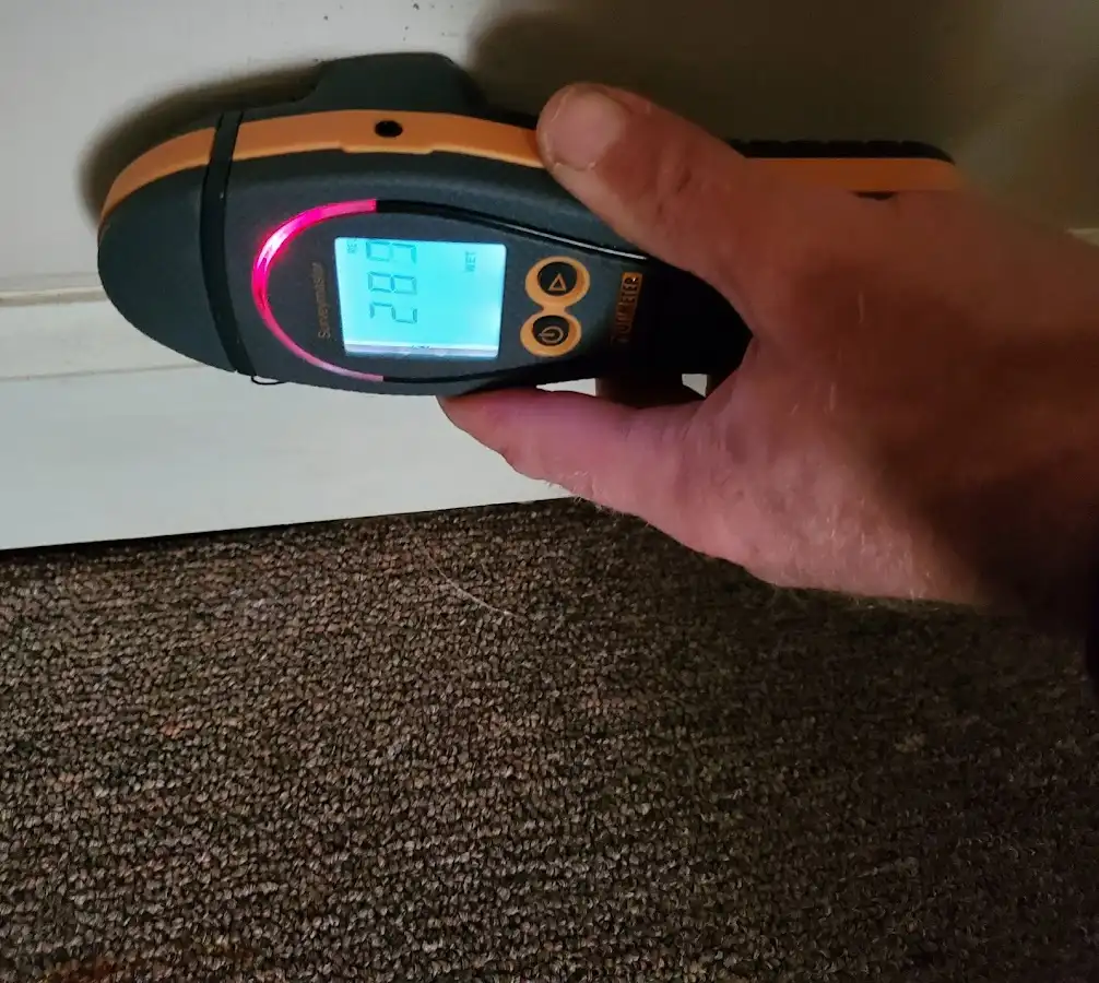 Moisture detection at baseboard during Storm Damage Restoration in Longview